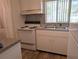 Functional kitchen design with laminate countertops and white appliances at 5895 17Th W St # B-26, Bradenton, FL 34207