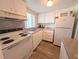 A bright kitchen with white appliances and laminate countertops at 5895 17Th W St # B-26, Bradenton, FL 34207