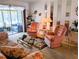 Comfortable living room featuring a floral sofa and two pink upholstered chairs at 5895 17Th W St # B-26, Bradenton, FL 34207