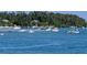 Scenic waterfront view featuring numerous boats anchored in a calm, clear bay surrounded by lush tropical foliage at 5895 17Th W St # B-26, Bradenton, FL 34207