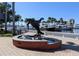 A bronze manatee statue and fountain, with a view of boats at the waterfront at 5895 17Th W St # B-26, Bradenton, FL 34207