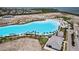 Community's large lagoon surrounded by tropical landscaping with a white sandy beach and modern amenity buildings at 5910 Red Mangrove Ln, Bradenton, FL 34210