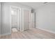 Bedroom featuring an open bathroom with tub, wood-look floors and access to closet at 5910 Red Mangrove Ln, Bradenton, FL 34210