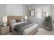 Bedroom with a nicely decorated bed, modern side tables, wood-look flooring, and a window with shutters at 5910 Red Mangrove Ln, Bradenton, FL 34210