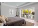 Bright bedroom featuring a view of the pool, light-colored walls, and contemporary decor at 5910 Red Mangrove Ln, Bradenton, FL 34210