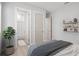 Bedroom featuring a modern bed, plant and shelving and open bathroom with tub at 5910 Red Mangrove Ln, Bradenton, FL 34210