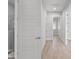 Clean hallway featuring doors and views of rooms with wood floors and light walls at 5910 Red Mangrove Ln, Bradenton, FL 34210