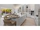 Spacious kitchen with white cabinets, stainless steel appliances, and large center island at 5910 Red Mangrove Ln, Bradenton, FL 34210