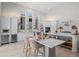 White open kitchen featuring stainless appliances, island seating, and sliding glass doors to patio at 5910 Red Mangrove Ln, Bradenton, FL 34210
