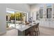 Contemporary kitchen boasts stainless appliances, white cabinets, and a breakfast bar at 5910 Red Mangrove Ln, Bradenton, FL 34210
