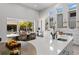 Bright kitchen featuring a large island with seating, modern appliances, floating shelves, and access to outdoor pool at 5910 Red Mangrove Ln, Bradenton, FL 34210