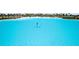 Beautiful lagoon view with a person paddle boarding, showing the active lifestyle at 5910 Red Mangrove Ln, Bradenton, FL 34210