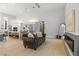 A modern living space with a cozy sofa, fireplace, open kitchen, and wood floors at 5910 Red Mangrove Ln, Bradenton, FL 34210