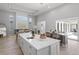 Spacious living area with a fireplace, wood floors, island seating, and sliding doors to the pool area at 5910 Red Mangrove Ln, Bradenton, FL 34210