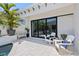 Outdoor patio features tiled flooring, comfortable seating, and a black framed sliding glass door at 5910 Red Mangrove Ln, Bradenton, FL 34210
