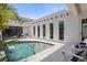 Luxury pool with palm trees, waterfall feature, and elegant patio furniture, creating a serene outdoor oasis at 5910 Red Mangrove Ln, Bradenton, FL 34210