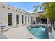 Stunning private pool features tiled decking, luxurious outdoor seating, and multiple windows along the rear of the home at 5910 Red Mangrove Ln, Bradenton, FL 34210