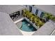 Aerial view of a private pool with palm trees, a waterfall feature, and an outdoor seating area in courtyard at 5910 Red Mangrove Ln, Bradenton, FL 34210