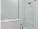 Detailed view of a modern shower with tiled walls, glass doors, and built-in shelves at 5910 Red Mangrove Ln, Bradenton, FL 34210