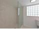 Updated bathroom with glass shower and privacy window at 5924 Gulf Of Mexico Dr, Longboat Key, FL 34228