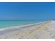 Picturesque beach view showcasing the clear blue water and sandy shoreline at 5924 Gulf Of Mexico Dr, Longboat Key, FL 34228