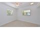 Minimalist bedroom with terrazzo flooring and bright natural light from two windows at 5924 Gulf Of Mexico Dr, Longboat Key, FL 34228