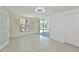 Bright bedroom featuring double doors to the outdoor pool at 5924 Gulf Of Mexico Dr, Longboat Key, FL 34228