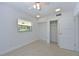 Simple bedroom with terrazzo flooring, closet, and bright windows offering neighborhood views at 5924 Gulf Of Mexico Dr, Longboat Key, FL 34228