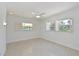Bright bedroom featuring terrazzo floors, shuttered windows, and a ceiling fan at 5924 Gulf Of Mexico Dr, Longboat Key, FL 34228