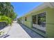 View of the exterior of the house with sliding glass doors and an outdoor area at 5924 Gulf Of Mexico Dr, Longboat Key, FL 34228