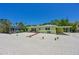 Charming single story home with a covered carport and mature landscaping at 5924 Gulf Of Mexico Dr, Longboat Key, FL 34228
