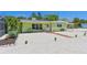 Charming single story home with mature landscaping and a white gravel driveway at 5924 Gulf Of Mexico Dr, Longboat Key, FL 34228