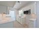 Bright kitchen featuring white cabinets and stone countertops at 5924 Gulf Of Mexico Dr, Longboat Key, FL 34228