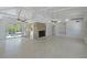 Bright living room featuring a fireplace, a beamed ceiling, and an open floorplan to kitchen at 5924 Gulf Of Mexico Dr, Longboat Key, FL 34228