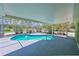 Kidney-shaped pool, screened enclosure, and tropical landscaping offer a private outdoor oasis at 5924 Gulf Of Mexico Dr, Longboat Key, FL 34228