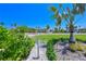 Well-maintained yard with lush green grass and mature trees near a public street at 5924 Gulf Of Mexico Dr, Longboat Key, FL 34228