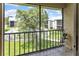 Balcony overlooking a grassy lawn, pool, and surrounding condo buildings at 5964 7Th W Ave # 5964, Bradenton, FL 34209