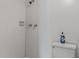 Bathroom with white tiled shower and toilet, offering essential amenities at 5964 7Th W Ave # 5964, Bradenton, FL 34209