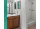 Bathroom with wood vanity, sink, mirror, and a tiled walk-in shower at 5964 7Th W Ave # 5964, Bradenton, FL 34209