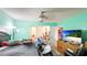 Bedroom with a ceiling fan, dresser with a TV, and closet access at 5964 7Th W Ave # 5964, Bradenton, FL 34209