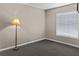 Empty bedroom with carpet, neutral walls, a window, and a standing lamp at 5964 7Th W Ave # 5964, Bradenton, FL 34209