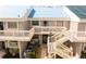Exterior of a two-story condo building with white railings and lush landscaping at 5964 7Th W Ave # 5964, Bradenton, FL 34209