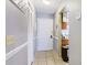 Inviting hallway with neutral tones, tiled flooring, closet, and a glimpse into the kitchen area at 5964 7Th W Ave # 5964, Bradenton, FL 34209