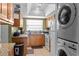 Efficient kitchen with essential appliances and stacked washer/dryer at 5964 7Th W Ave # 5964, Bradenton, FL 34209