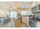 Modern kitchen with stainless steel appliances, white cabinetry, and bar seating at 6151 Bahia Del Mar Blvd # 123, St Petersburg, FL 33715