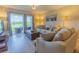Comfortable living room with tiled floors and walk out access to the lanai at 6151 Bahia Del Mar Blvd # 123, St Petersburg, FL 33715