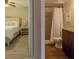 Bright main bedroom featuring hardwood floors, a ceiling fan, and a connected bathroom for convenience at 6151 Bahia Del Mar Blvd # 123, St Petersburg, FL 33715