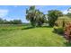 Expansive backyard featuring lush greenery and mature palm trees, offering a private outdoor space at 6664 Deering Cir, Sarasota, FL 34240
