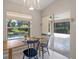 Cozy dining nook with sliding glass doors offering a view of the screened-in pool area at 6664 Deering Cir, Sarasota, FL 34240