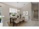Inviting dining room featuring a modern chandelier, large windows, and a stylish buffet at 6664 Deering Cir, Sarasota, FL 34240